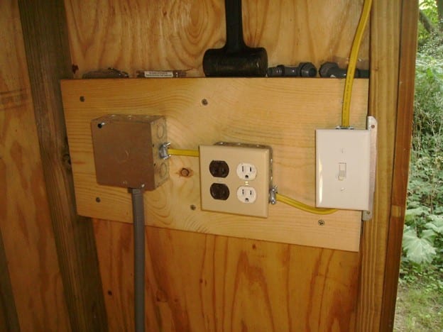 Adding electricity to a storage shed.