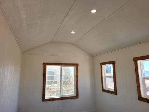 10x16 Gable Style Shed w/ Porch interior showing the finished ceiling wired up with electric lights.