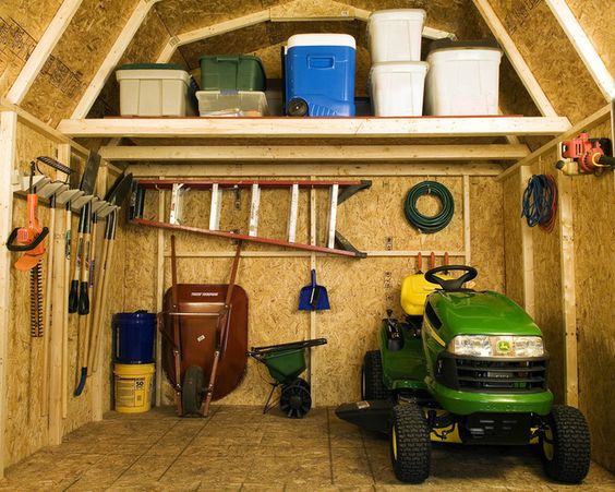 An organized storage shed with a loft to help keep things organized.