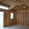 A view from the inside of a 12x16 Studio Gable storage shed, with exposed studs and plywood.