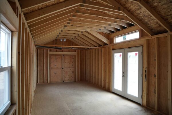 Studio Gable 12x28 storage shed viewed from the inside, facing the double swinging doors.