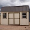 10x16 Barn Style storage shed with double doors and two windows viewed from the front.