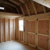 Interior view of the 10x16 Barn Style storage shed showing the double doors and windows.
