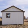 Gable storage shed w/ Porch 14x32 prepared for a more residential use, viewed from the back, highlighting one window in the back.