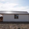 Gable storage shed w/ Porch 14x32 prepared for a more residential use, viewed from the right side.
