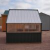 Side view of an 8x8 Green House with wood frame, metal siding and roof, and plastic covering on the upper walls.