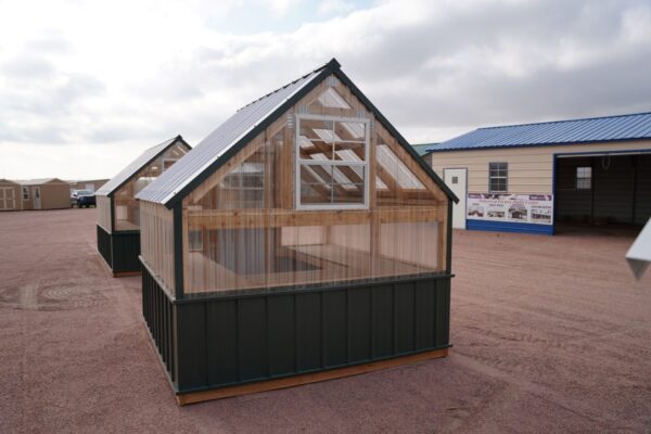 Back view of an 8x8 Green House with wood frame, metal siding, and plastic covering on the upper walls, showing the window in the back.