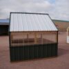 Side view of an 8x8 Green House with wood frame, metal siding and roof, and plastic covering on the upper walls.