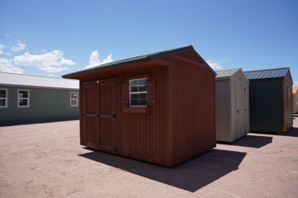 Tackroom Style 8x12 storage shed with wood siding, double doors, and a window.