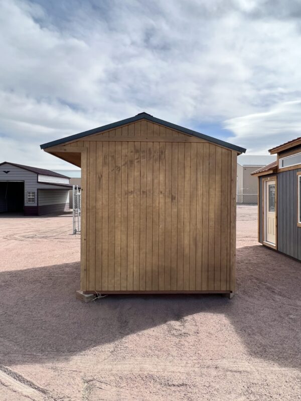 Discover the practicality and visual appeal of our 8x10 Loafing storage shed from a left-side perspective, featuring durable brown wooden paneling and a captivating green roof with a generous overhang, providing a functional and stylish solution for your storage needs.
