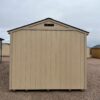 A wooden shed stands in the middle of an outdoor landscape, surrounded by a bright blue sky and fluffy white clouds.
