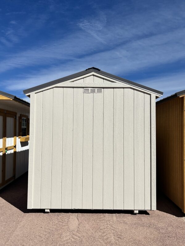 Discover the spaciousness of our 8x14 Gable Style storage shed as you view it from the back, showcasing its wide design and light grey wooden paneling. This versatile shed offers ample room for all your storage needs while exuding a contemporary and stylish appeal that seamlessly integrates with your outdoor space.