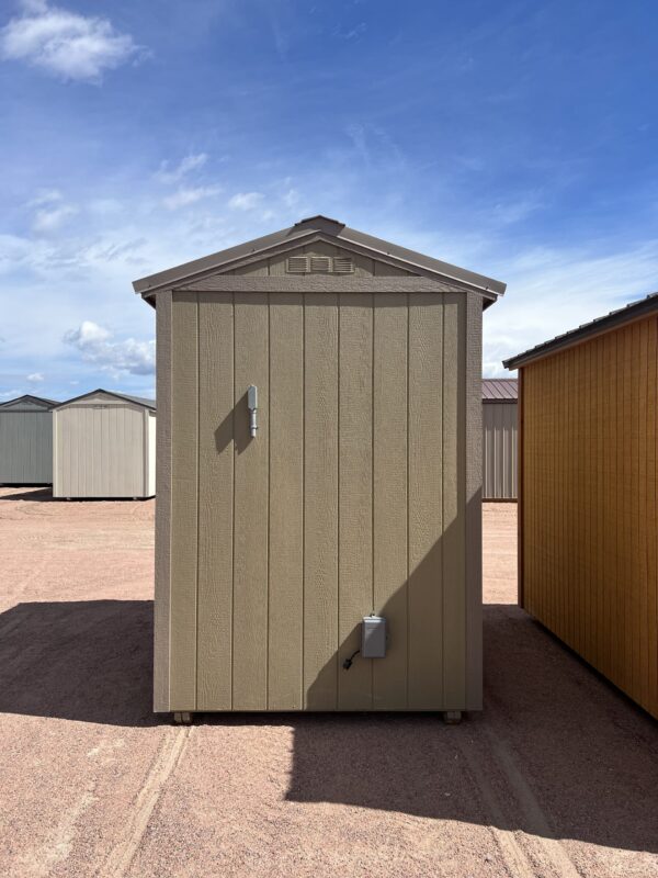 A view of the side of a beige 6x8 Gable Style storage shed with Interior Finish, displaying electrical connections on the side.