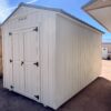 Experience the inviting front view of our 8x14 Gable Style storage shed, featuring two swinging wooden doors that create a welcoming entrance. The clean lines and light grey wooden paneling of the shed's exterior add a touch of modern sophistication, making it a practical and aesthetically pleasing storage solution for your property.