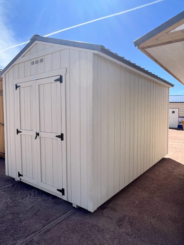 Experience the inviting front view of our 8x14 Gable Style storage shed, featuring two swinging wooden doors that create a welcoming entrance. The clean lines and light grey wooden paneling of the shed's exterior add a touch of modern sophistication, making it a practical and aesthetically pleasing storage solution for your property.