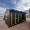 10x20 Loafing Shed with Tackroom large shed with double doors plus a large open entrance and a window. Green walls and wooden trim, metal roof.