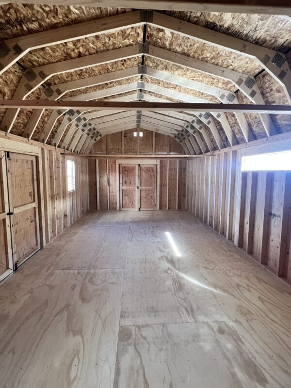 Stand at one end of our generous 14x32 Barn Style storage shed and marvel at the vast expanse of space that stretches all the way to the other end. This remarkable interior offers an abundance of room to accommodate your storage requirements, providing you with the freedom to organize and arrange your belongings with ease. Experience the convenience of ample space within this expansive storage solution.