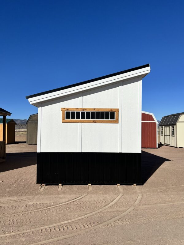 Side view of the 10x20 Royal Gorge Style storage shed revealing a long, short window that adds a touch of charm and natural light. This versatile shed combines functionality with aesthetic appeal, providing a perfect storage solution with a delightful architectural detail.