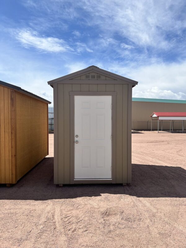 The sky is dotted with clouds as a 6x8 Gable Style storage shed with Interior Finish stands in the foreground.