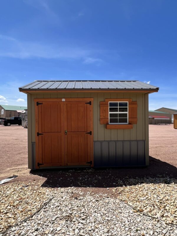 8x12 Tackroom Style storage shed with double doors and a window on the side, viewed from the front.
