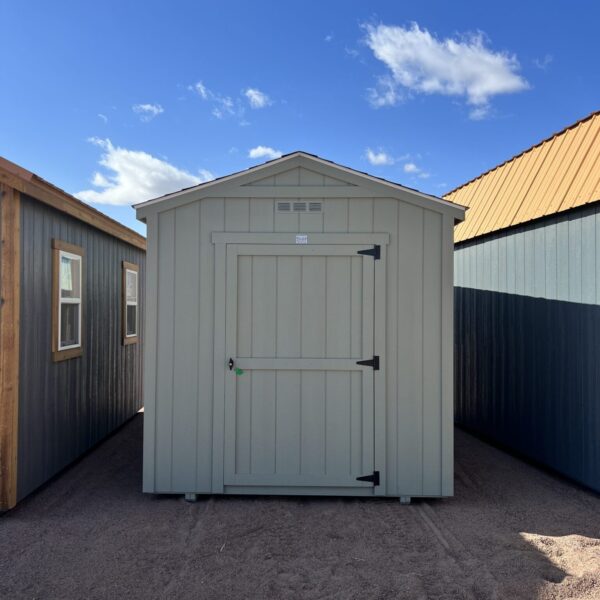 A view of the 8x14 Gable Style storage shed from the front, with the sky behind it dotted with clouds.