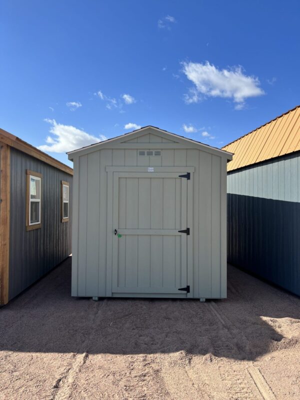 A view of the 8x14 Gable Style storage shed from the front, with the sky behind it dotted with clouds.