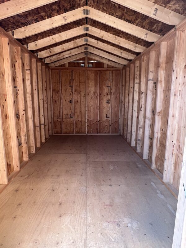 The wooden walls and ceiling of the room create a warm atmosphere inside the 8x14 Gable Style storage shed.