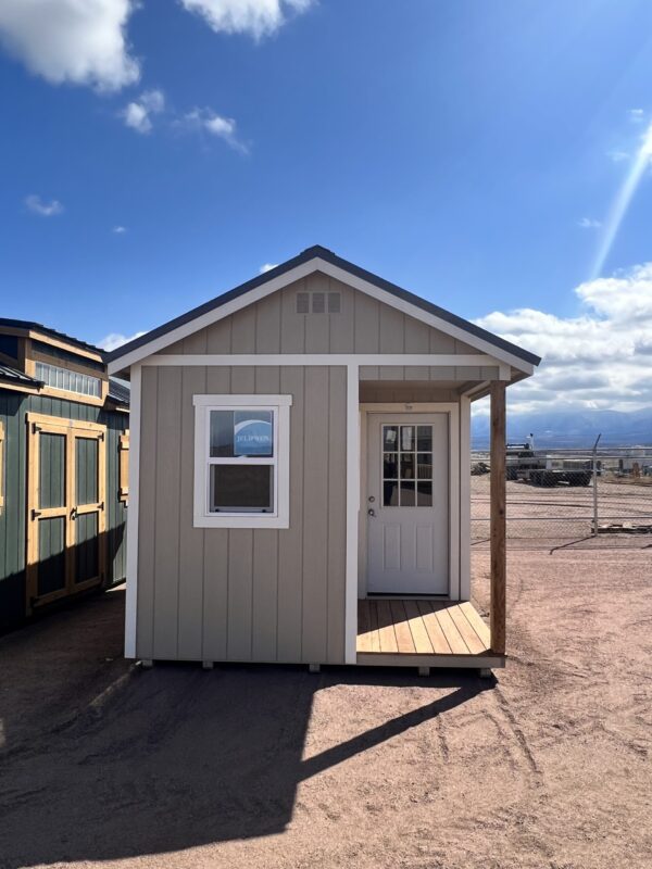 Take in the side view of our 10x16 Gable storage shed, showcasing its extended porch, complete with a door and an adjacent window. This angle highlights the seamless integration of the functional storage area with the inviting porch, offering a versatile outdoor space for relaxation and convenience.