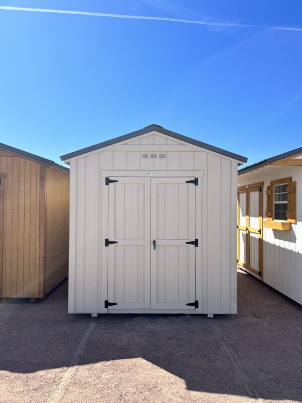 Take in the front view of our 8x14 Gable Style storage shed, revealing its stylish design and attention to detail. The light grey wooden paneling enhances the shed's aesthetic appeal, while the symmetrical lines and proportions create a balanced and pleasing visual impact. This practical storage solution is as visually appealing as it is functional, making it a standout addition to your property.