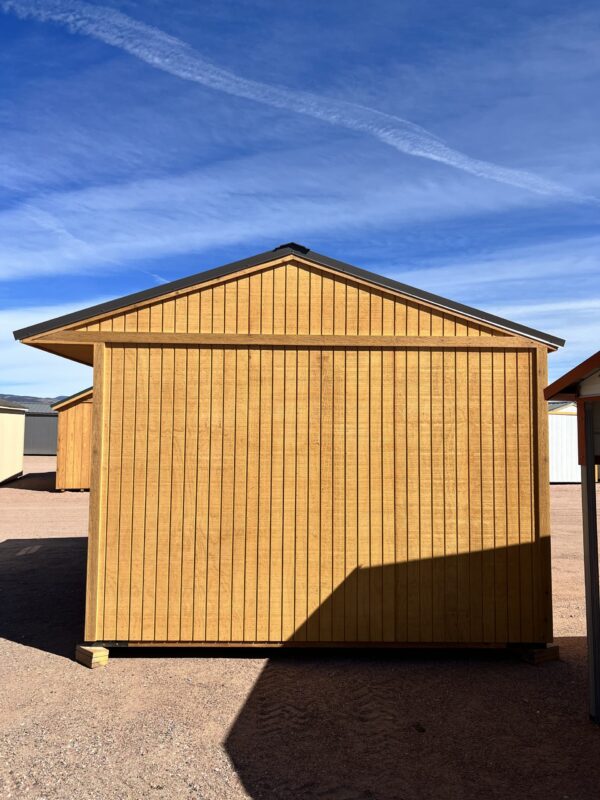 View the right side of our 12x12 Loafing shed, notable for its expansive roof overhang that provides added protection and aesthetic appeal. The golden brown exterior seamlessly blends with the generous roof design, creating a visually pleasing and functional storage solution.