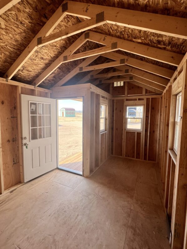 Experience the spacious interior of our 10x16 Gable storage shed as you peer out from the open door. The inviting ambiance of the shed's interior invites you to customize and organize your belongings while providing a tranquil and functional space for your storage needs.
