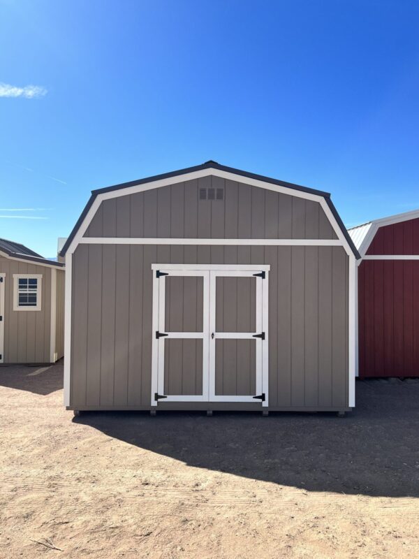 Face the front of our 14x32 Barn Style storage shed head-on and behold the striking presence of the double doors that greet you. This direct view showcases the grand entrance of the shed, emphasizing its impressive size and providing easy access to the expansive interior.
