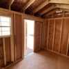Interior view of the 8x12 Tackroom Style storage shed, facing out of the double doors.