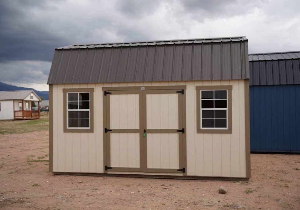 10x16 Barn Style storage shed with double doors and two windows viewed from the front.