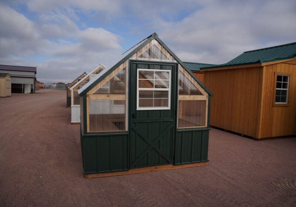 Front view of an 8x8 Green House with wood frame, metal siding, and plastic covering on the upper walls