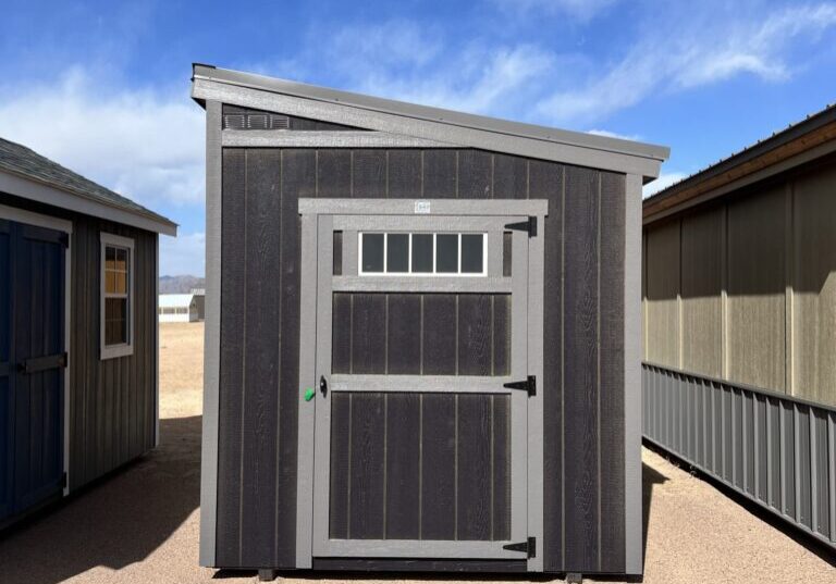 Discover our modern 8x12 Urban Style storage shed, featuring a sleek grey door and an eye-catching angled roof, perfectly blending functionality with contemporary design.