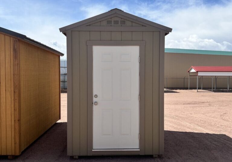 The sky is dotted with clouds as a 6x8 Gable Style storage shed with Interior Finish stands in the foreground.