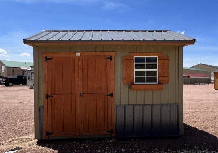 8x12 Tackroom Style storage shed with double doors and a window on the side, viewed from the front.
