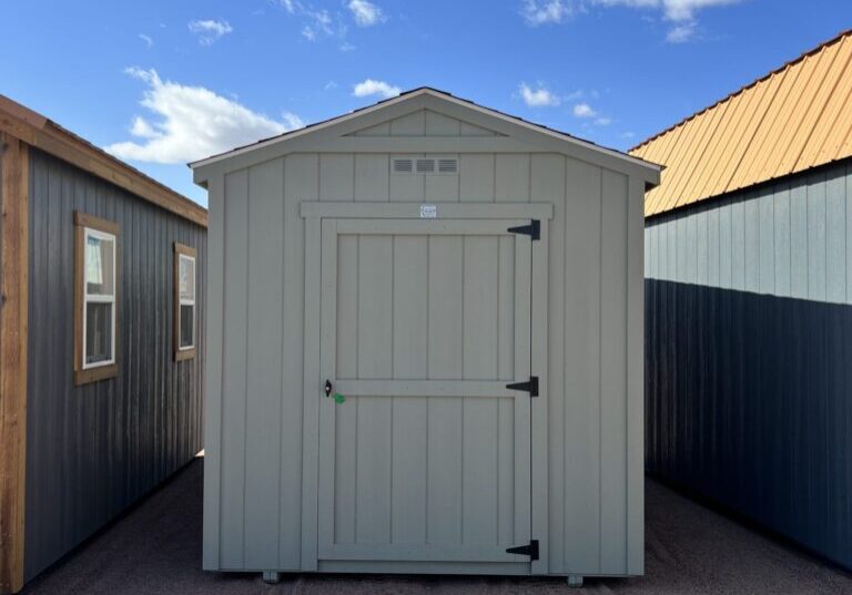 A view of the 8x14 Gable Style storage shed from the front, with the sky behind it dotted with clouds.